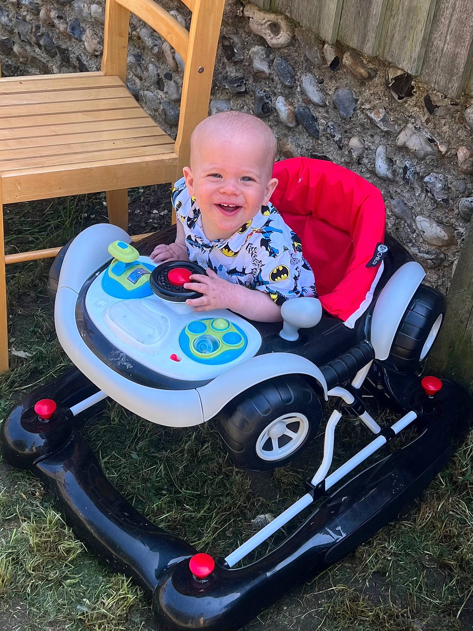 Archie is registered to the contest to win money with this photo: auto_part, automotive_design, baby, baby_products, baby_toddler_clothing, child, electric_blue, fun, grass, joy, motor_vehicle, person, riding_toy, sitting, smile, t_shirt, tire, toddler, toy, toy_vehicle