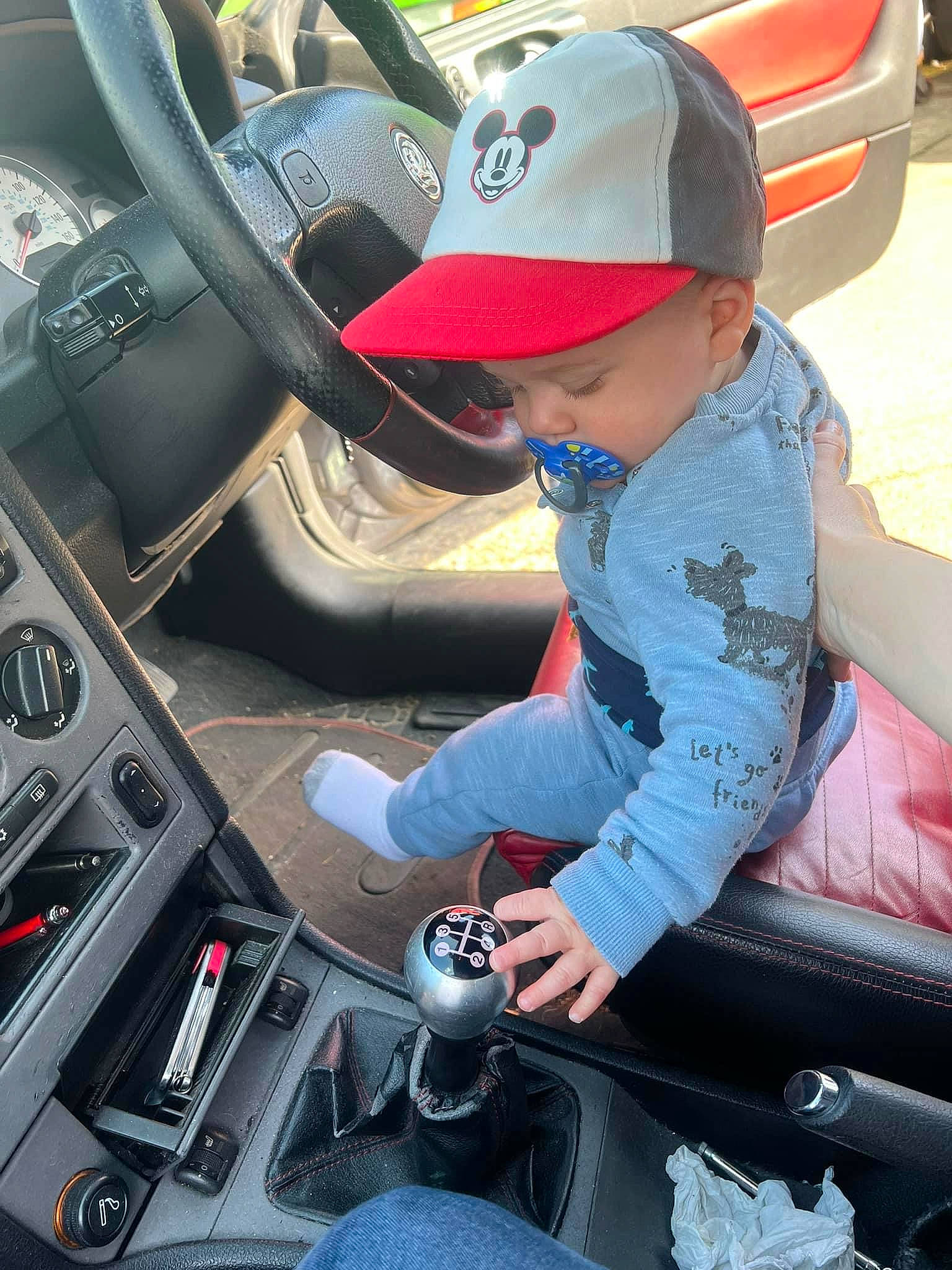 Archie is registered to the contest to win money with this photo: auto_part, automotive_design, automotive_exterior, automotive_lighting, automotive_tire, automotive_wheel_system, car, car_seat, car_seat_cover, center_console, gear_shift, headwear, helmet, mode_of_transport, motor_vehicle, person, personal_luxury_car, steering_part, steering_wheel, vehicle
