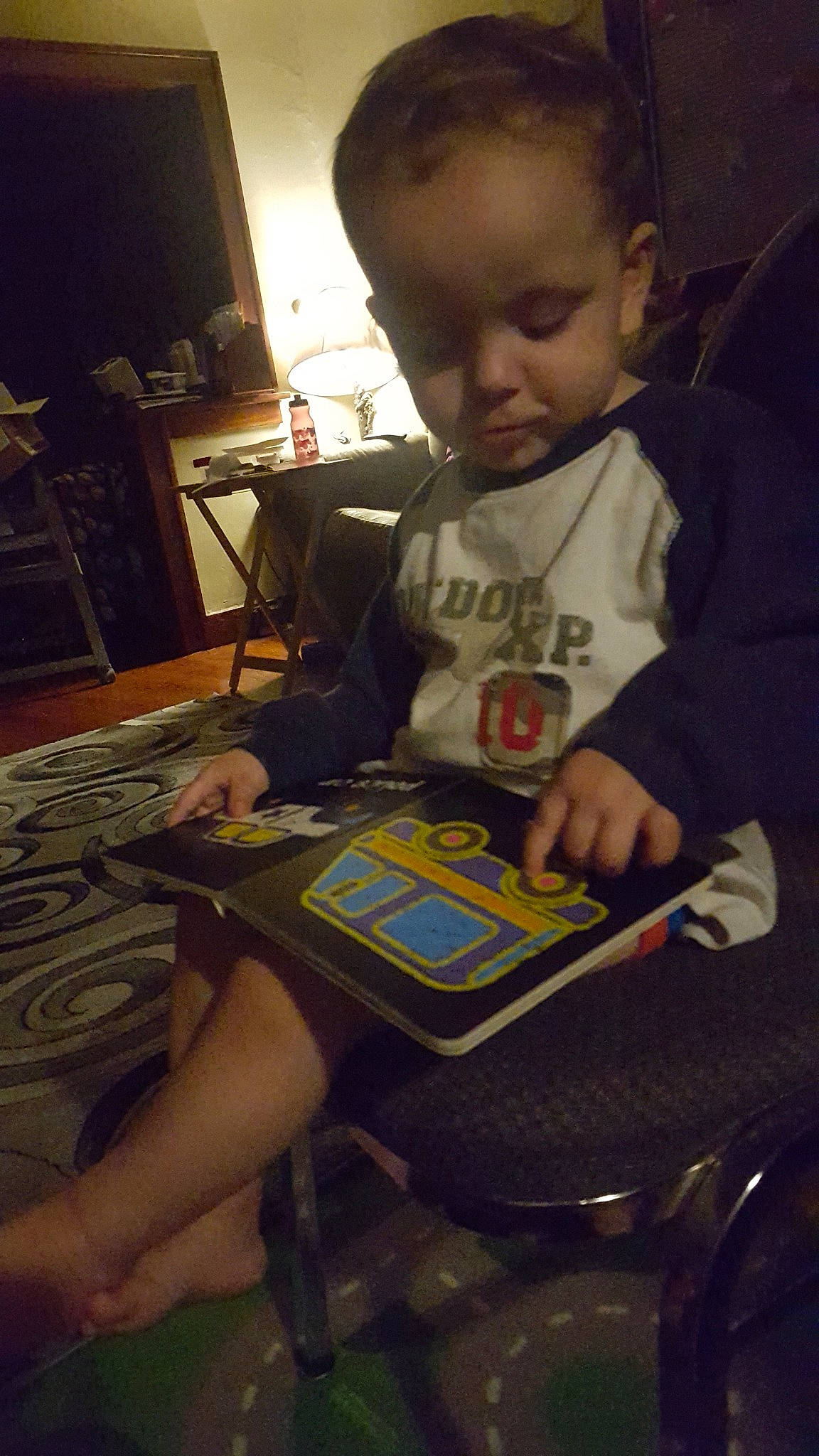 Elisha is registered to the contest to win money with this photo: child, fun, homework, person, play, reading, sitting, toddler