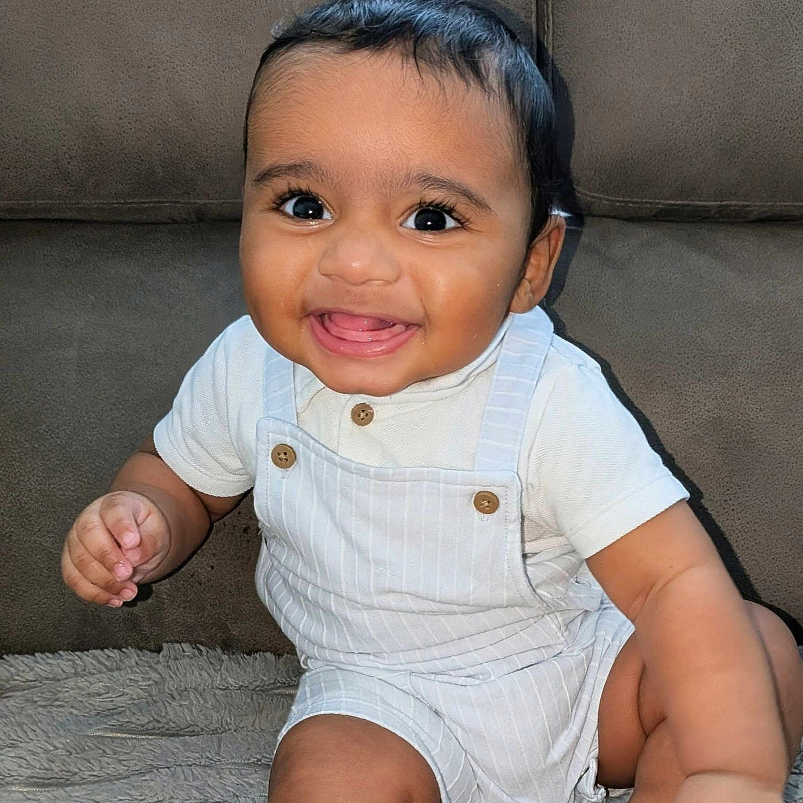 Daelen joined the competition — help win amazing prizes! baby, buttons, child, clothing, cute, eyes, face, hand, happy, indoors, infant, legs, person, portrait, sitting, skin, smiling, soft_surface, white_outfit, young