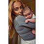 Ollie joined the competition — help win amazing prizes! woman, baby, child, person, portrait, indoor, holding, face, expression, curious, blonde_hair, long_hair, light, skin, clothing, casual, closeup, smile, tender, affection