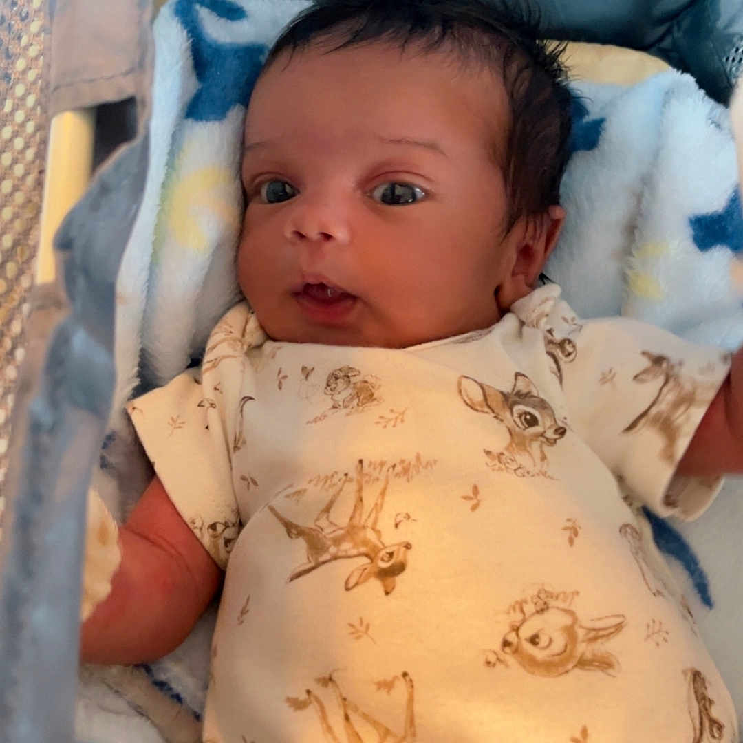 Kyaire is registered to the contest to win money with this photo: baby, bed, blanket, cradle, crib, cushion, face, furniture, head, homedecor, infantbed, newborn, person, photography, portrait