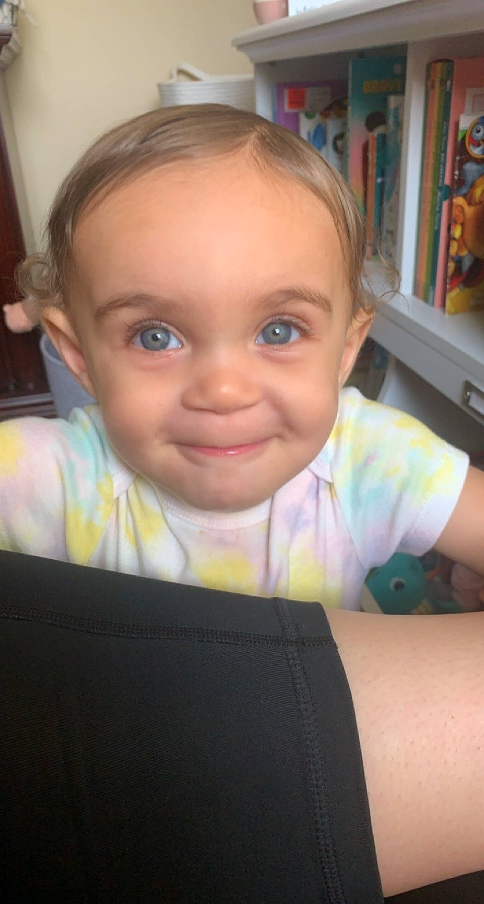 Amya joined the competition — help win amazing prizes! bookcase, cheek, chin, ear, eyebrow, eyelash, facial_expression, finger, forehead, fun, happy, iris, joy, lip, mouth, nose, person, shelf, shelving, skin