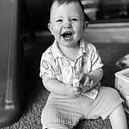 Sasha a rejoint le concours — aidez-le/la à gagner de superbes lots ! baby, child, smiling, sitting, carpet, snack, shorts, shirt, indoors, black_and_white, happy, portrait, cute, hands, face, expression, person, young_child, infant, play