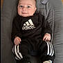 Elyo participe au concours pour gagner de l'argent avec cette photo : adidas, baby, baby_seat, black_outfit, child, clothing, comfortable, cushion, cute, fashion, footwear, indoor, infant, person, portrait, relaxed, smiling, sneakers, wide_eyes, young_child