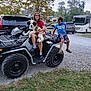 atv, camper, campground, casual_clothing, child, dog, footwear, grass, gravel, happy, jeep, nature, outdoor, person, pet, recreation, smile, toyota, tree, vehicle
