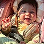baby, blanket, car_seat, child, clothing, colorful, cute, face, hand, happy, head, indoor, infant, portrait, seatbelt, smiling, soft_texture, sunlight, teething_toy, toy
