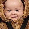 baby, child, smile, face, costume, bear_costume, fur, hood, zipper, straps, cute, infant, portrait, closeup, happy, chubby_cheeks, eyes, clothing, warm, seatbelt