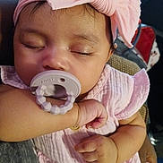 Mileah joined the competition — help win amazing prizes! adorable, arm, baby, child, closeup, cute, face, hand, headband, indoor, infant, newborn, pacifier, peaceful, person, pink_clothing, resting, sleeping, soft_texture, toddler