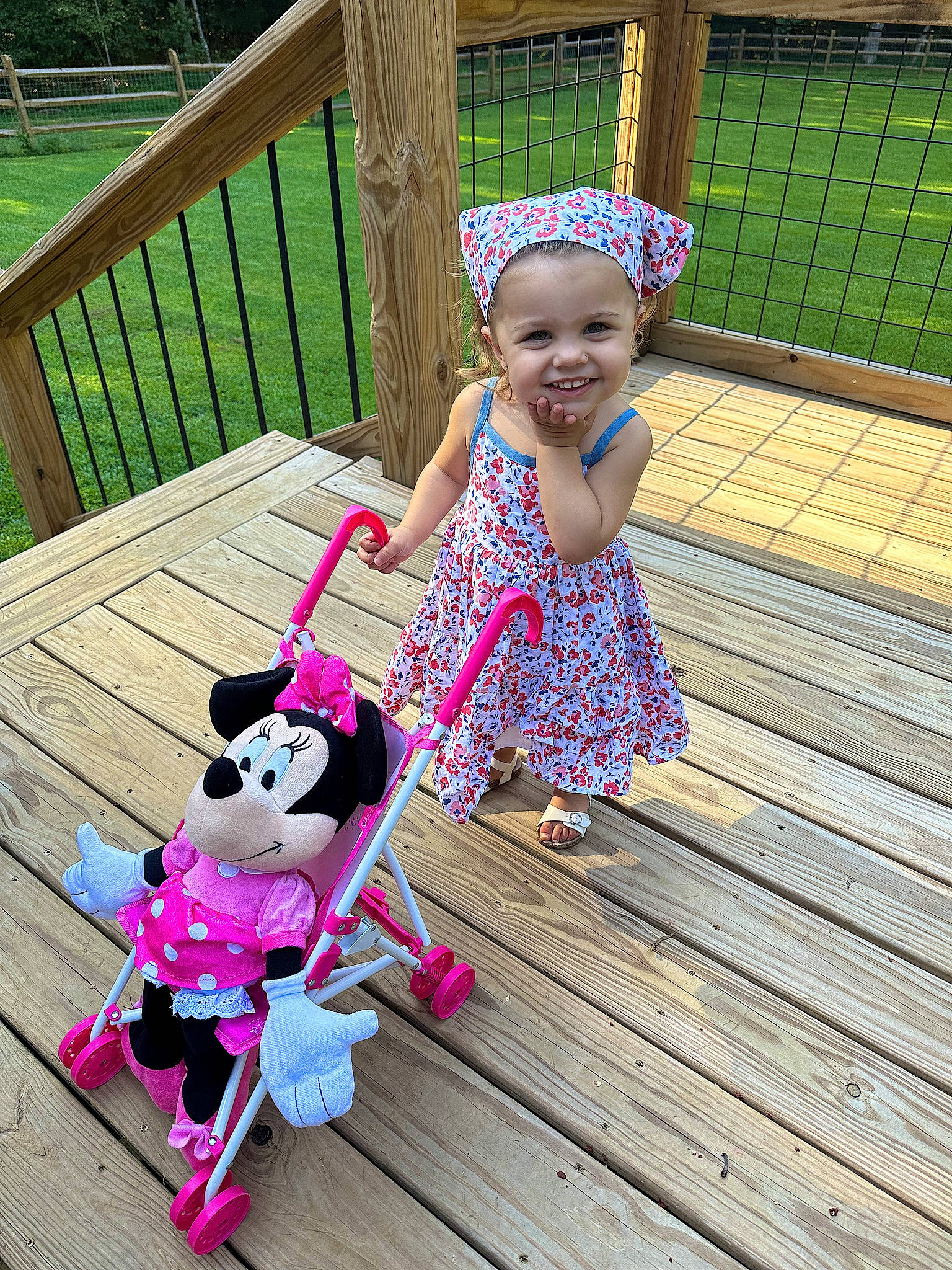 Ayla is registered to the contest to win money with this photo: baby_toddler_clothing, child, deck, fence, fun, grass, green, happy, joy, leisure, magenta, pattern, person, pink, play, purple, recreation, skin, smile, toddler