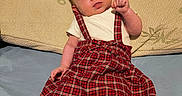 Lila joined the competition — help win amazing prizes! baby, bamboo, bed, casual, clothing, curious_expression, cute, fabric, indoor, infant, person, pillow, plaid_skirt, portrait, resting, sleepwear, suspenders, tights, wooden_headboard, young_child