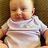 baby, baby_boy, baby_girl, brown_background, child, closeup, couch, cute, face, happy, indoors, infant, nike_logo, portrait, purple_clothing, sitting, skin, smile, soft_lighting, young_child