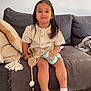 Isaac participe au concours pour gagner de l'argent avec cette photo : baby, blanket, bottle, child, couch, face, floor, furniture, hair, home, indoors, pacifier, pillow, sitting, smile, socks, striped_clothing, toy, wall_art, young_child