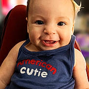 Eleia joined the competition — help win amazing prizes! baby, child, smiling, face, tank_top, hair_ponytail, clothing, blue, cute, portrait, sitting, infant, happy, person, indoor, closeup, young_child, expression, eyes, skin