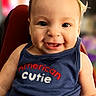 baby, child, smiling, face, tank_top, hair_ponytail, clothing, blue, cute, portrait, sitting, infant, happy, person, indoor, closeup, young_child, expression, eyes, skin