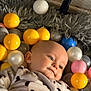 baby, child, ball_pit, colored_balls, yellow_balls, white_balls, pink_balls, gray_balls, blue_balls, panda_onesie, plush, soft_texture, infant, face, head, cute, indoor, smile, relaxed, portrait