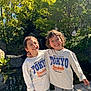 baseball, boys, casual_wear, child, curly_hair, friends, greenery, happy, hugging, matching_clothes, nature, outdoor, pond, rocks, siblings, smiling, sunlight, sweatshirt, trees, wooden_deck