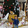 Imran a rejoint le concours — aidez-le/la à gagner de superbes lots ! celebration, child, christmas_tree, festive, floor_tiles, gift_box, happy, holiday_decorations, indoor, jacket, lights, ornaments, pants, person, railing, shoes, shopping_mall, smiling, stuffed_animals, winter_clothing