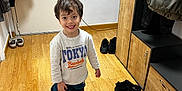 Imran a rejoint le concours — aidez-le/la à gagner de superbes lots ! boots, boy, cabinet, casual, child, clothing, door, floor, funny, happy, indoor, jacket, oversized, person, room, shoes, smiling, standing, wooden_floor, young