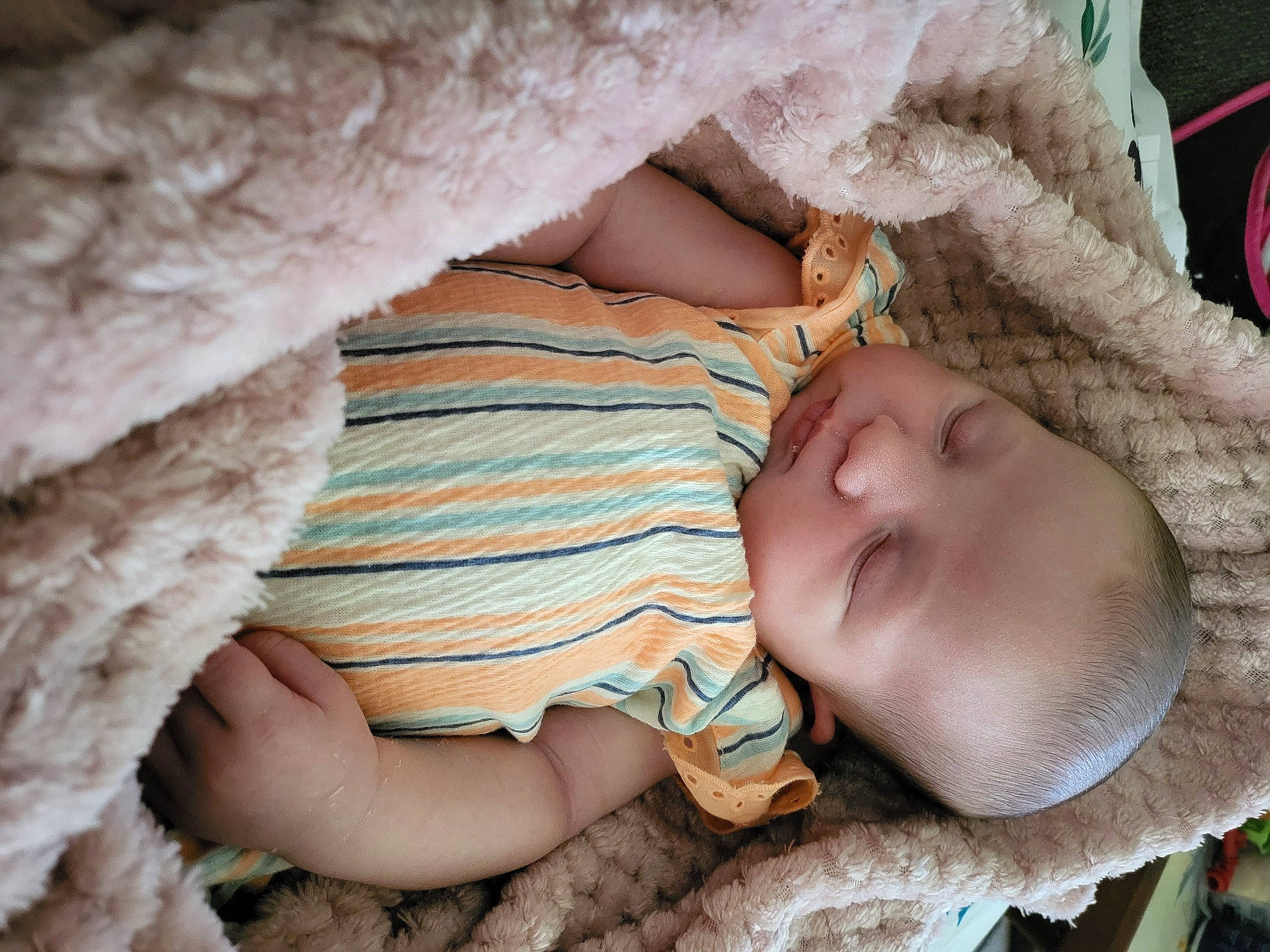 Priya is registered to the contest to win money with this photo: arm, baby, baby_toddler_clothing, cheek, child, comfort, eye, finger, hand, head, headgear, human_body, linens, mammal, mouth, person, skin, textile, toddler, tree