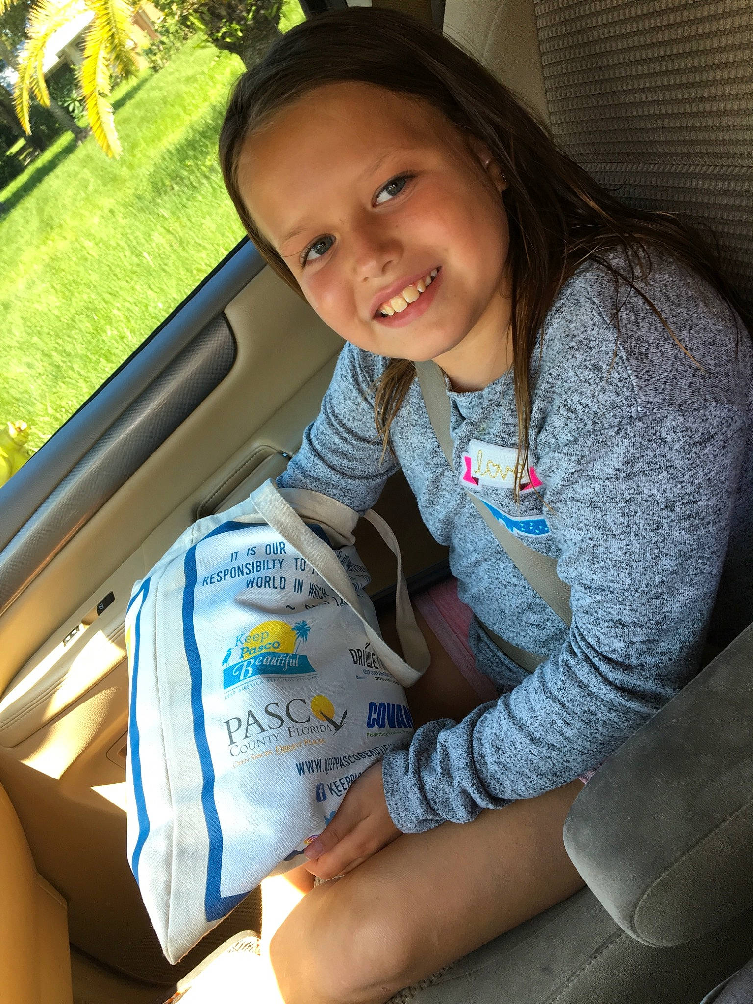 Mia is registered to the contest to win money with this photo: car_seat, child, joy, person, smile