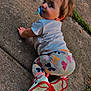 Addison is registered to the contest to win money with this photo: toddler, child, pacifier, crawling, sidewalk, concrete, grass, leggings, butterfly_pattern, white_shirt, red_shoes, curly_hair, outdoor, playful, young_child, casual_clothing, daylight, person, bare_hands, looking_back
