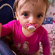Addison joined the competition — help win amazing prizes! toddler, pacifier, pink_shirt, child, indoor, close_up, curious, baby, face, eyes, toy, blanket, play_area, soft_toys, furniture, person, infant, cute, young_child, home