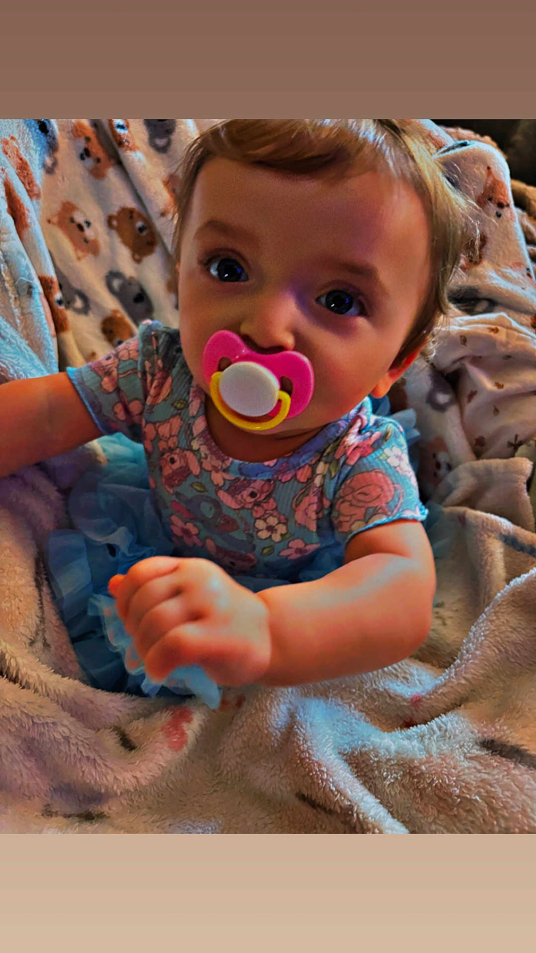 Addison joined the competition — help win amazing prizes! baby, pacifier, blanket, floral_dress, blue_tutu, infant, cute, child, indoors, cozy, closeup, face, hand, expression, person, young_child, soft_texture, animal_print, comfort, portrait