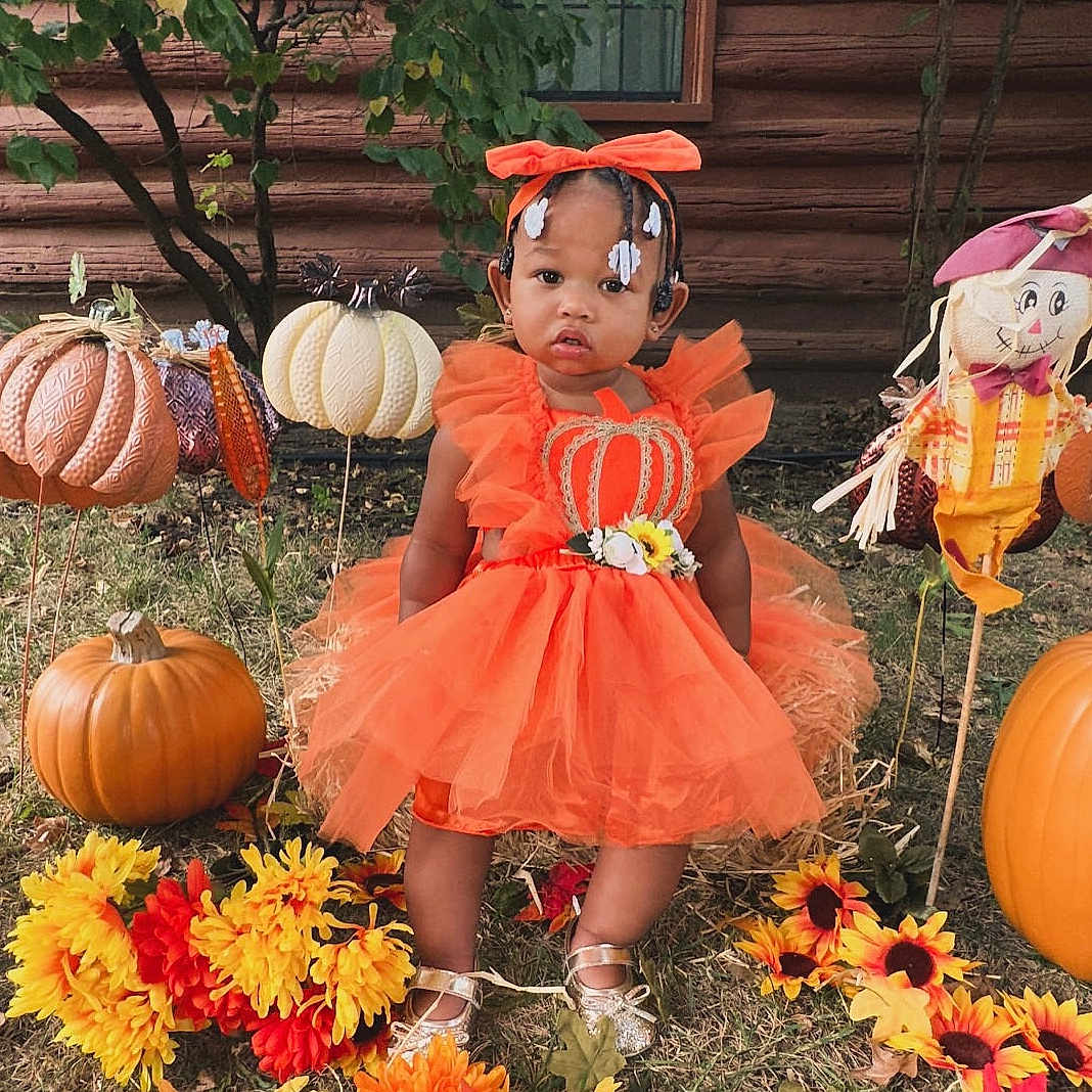 Jianni joined the competition — help win amazing prizes! autumn, child, cute, decoration, fall, festive, flower, grass, headband, holiday, nature, orange_dress, outdoor, portrait, pumpkin, scarecrow, seasonal, smiling, sunflower, toddler
