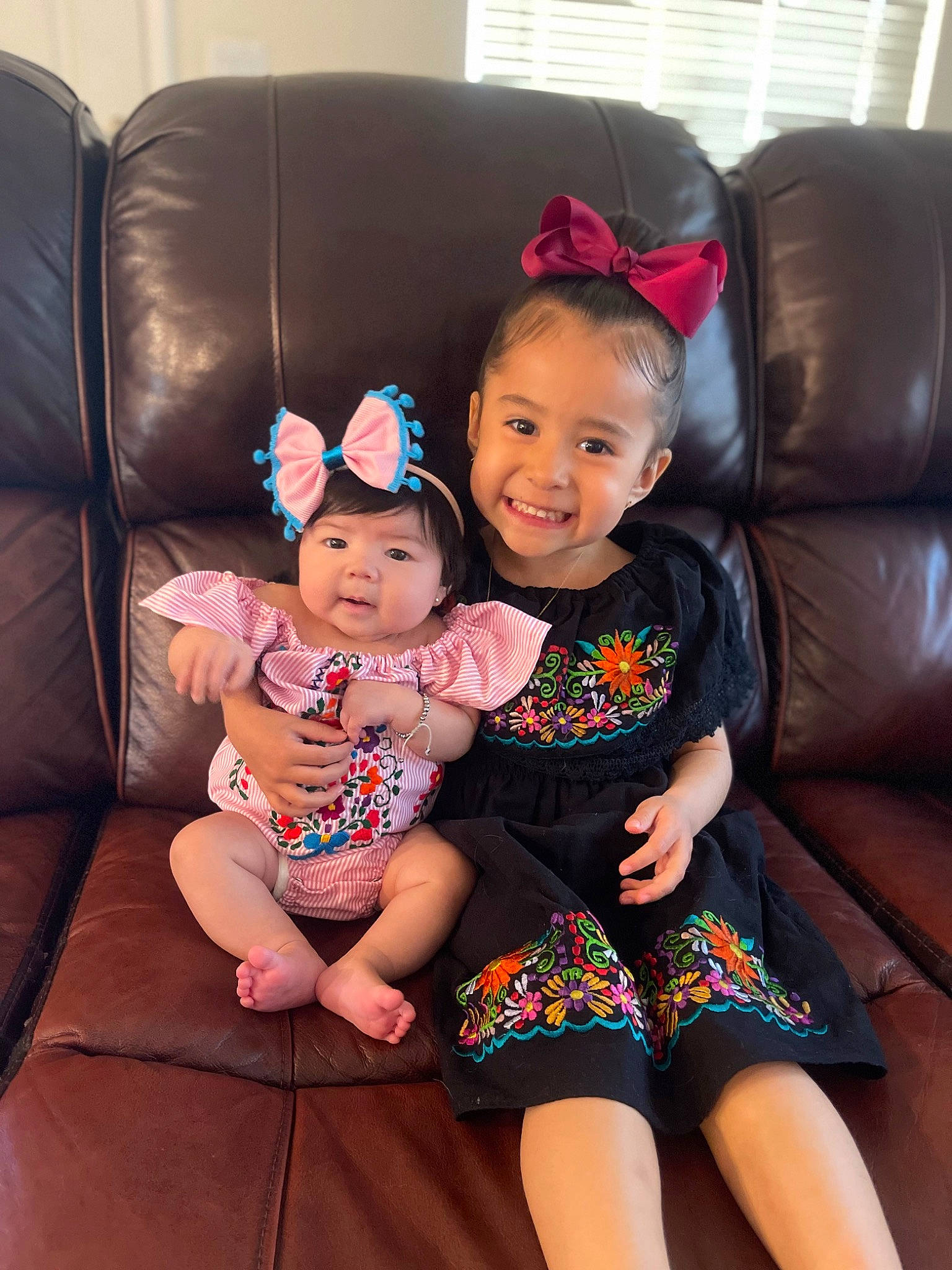 Emmalyn is registered to the contest to win money with this photo: baby_toddler_clothing, child, comfort, couch, face, facial_expression, fun, hair, hairstyle, happy, head, headwear, human, human_leg, joy, lap, leg, living_room, mammal, person