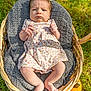 baby, infant, basket, blanket, floral_dress, headband, grass, outdoor, pumpkin, knit_blanket, feet, hands, serious_expression, cute, child, person, nature, seasonal, autumn, sunlight