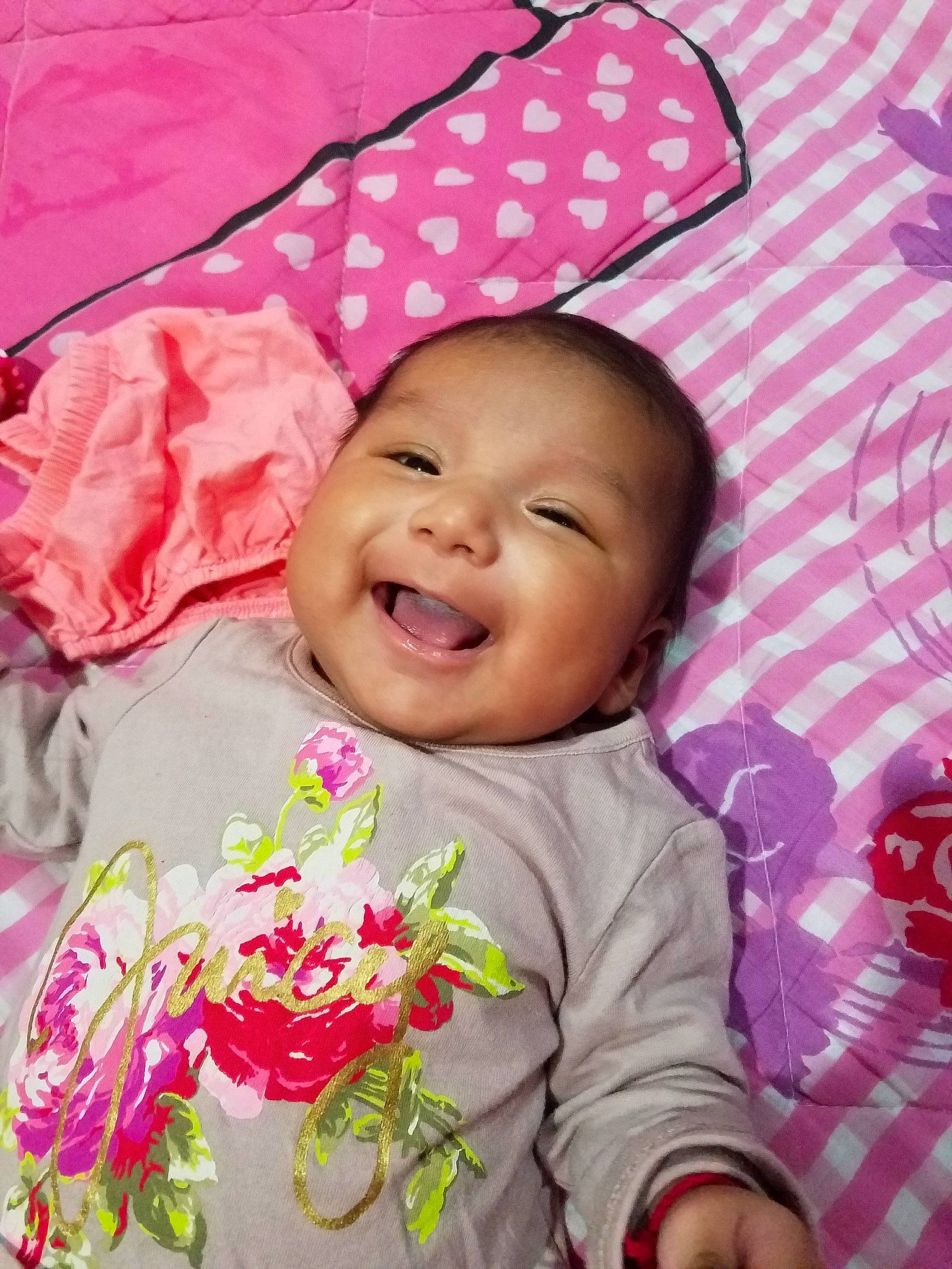 Angela is registered to the contest to win money with this photo: baby, cheek, child, face, facial_expression, flower, hair_accessory, happy, head, lip, person, pink, plant, product, skin, smile, textile, toddler