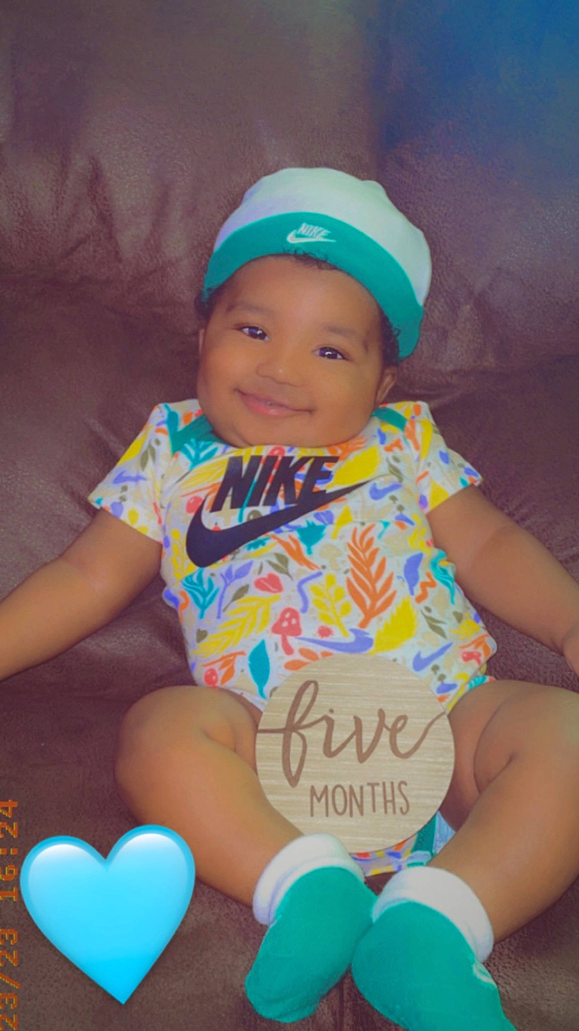 Kevin is registered to the contest to win money with this photo: aqua, baby, baby_toddler_clothing, balloon, baseball_cap, blue, cap, facial_expression, finger, fun, happy, headwear, joy, light, lighting, person, pink, sleeve, smile, t_shirt