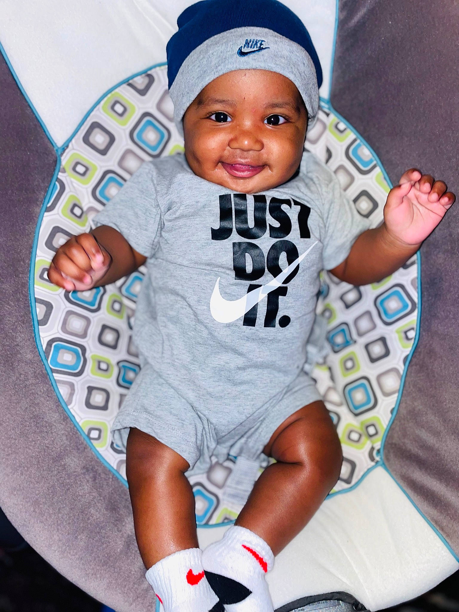 Kevin is registered to the contest to win money with this photo: baby, baby_toddler_clothing, baseball_cap, beanie, cap, carmine, child, electric_blue, facial_expression, happy, headwear, joy, pattern, person, pink, play, shorts, sleeve, smile, sock