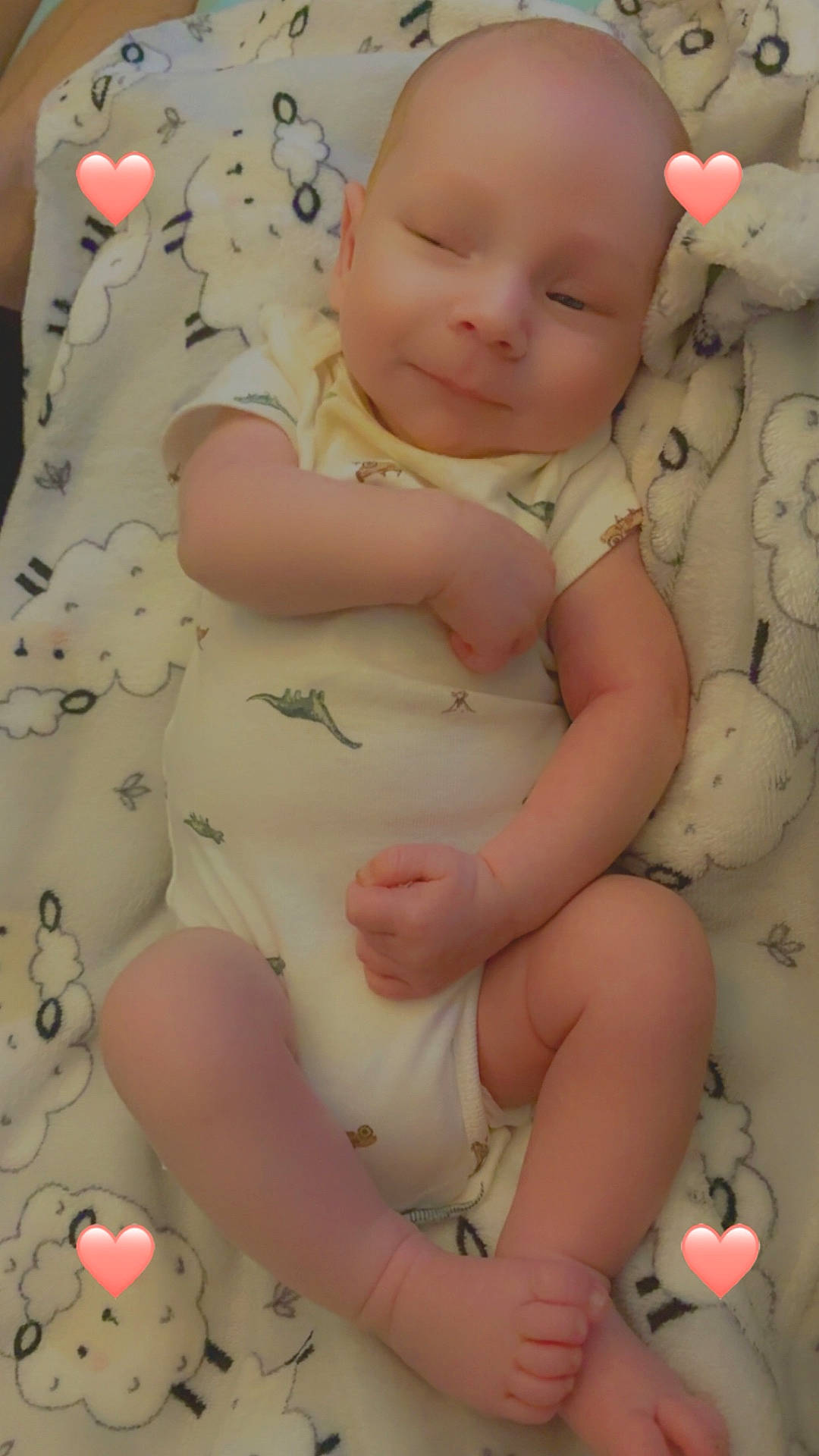 Isaiah is registered to the contest to win money with this photo: baby, blanket, closeup, cozy, cute, dinosaur_print, feet, hands, heart_sticker, infant, limbs, lying_down, newborn, onesie, portrait, sheep_pattern, skin, smiling, soft_texture, sticker