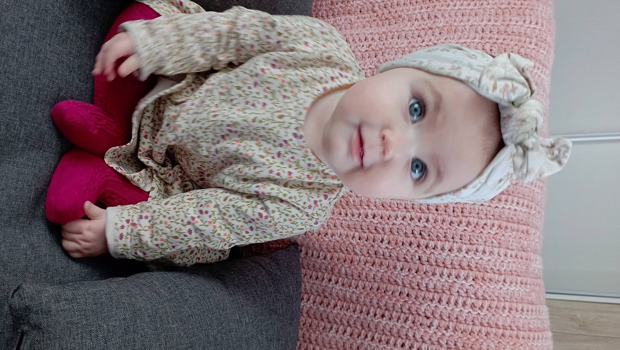 Nina participe au concours pour gagner de l'argent avec cette photo : baby, baby_toddler_clothing, cheek, child, comfort, eye, headgear, human_body, iris, knit_cap, lip, nose, outerwear, pattern, person, pink, product, skin, sleeve, toddler