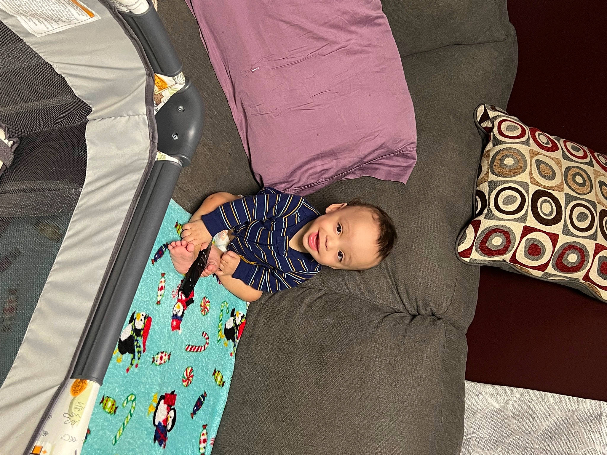 Landyn is registered to the contest to win money with this photo: baby, baby_products, baby_toddler_clothing, bedding, child, comfort, couch, event, fashion_accessory, linens, magenta, pattern, person, product, room, sitting, sleeve, t_shirt, textile, toddler