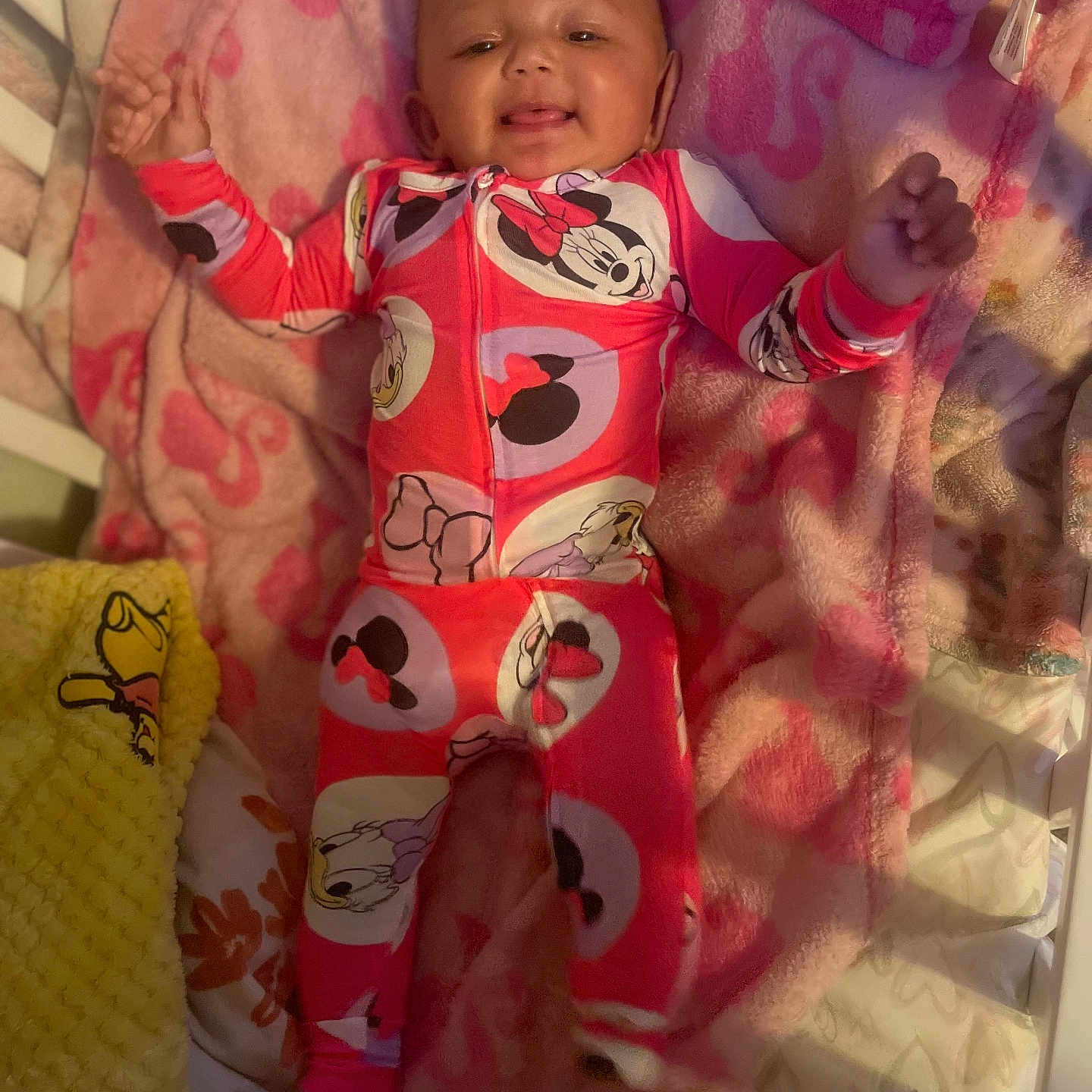 Kallie is registered to the contest to win money with this photo: baby, bed, blanket, child, cozy, crib, cute, disney, happy, indoor, infant, minnie_mouse, onesie, person, pink, portrait, sleepwear, smiling, soft_texture, toddler