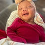 baby, infant, smile, headband, bow, blanket, red_clothing, cozy, cute, portrait, child, happy, indoors, soft_texture, closeup, newborn, sleepy, wrapped, person, warm