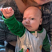 Heath joined the competition — help win amazing prizes! adult, baby, blanket, closeup, clothing, cozy, dinosaur_sleeper, face, facial_expression, glasses, gray_sweater, hand_raised, head, home, indoor, infant, parent_child, person, portrait, skin