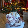 Amélia a rejoint le concours — aidez-le/la à gagner de superbes lots ! baby, child, smiling, christmas_tree, ornaments, lights, indoor, holiday, plush_chair, headband, floor_tiles, festive, cozy_clothing, happy, person, decor, warm_lighting, seated, infant, home