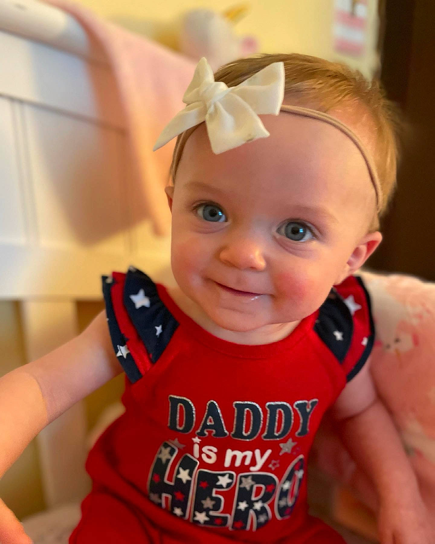 Lennox is registered to the contest to win money with this photo: arm, baby, baby_toddler_clothing, cheek, ear, elbow, eye, eyebrow, eyelash, finger, gesture, happy, iris, lip, neck, person, skin, sleeve, smile, thumb