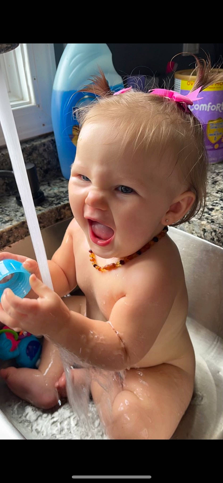 Ensleigh is registered to the contest to win money with this photo: baby, bathing, blue, cheek, chest, ear, face, finger, gesture, happy, head, human_body, iris, leg, mouth, nose, person, skin, smile, thumb