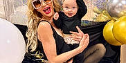Rayah joined the competition — help win amazing prizes! woman, baby, sunglasses, crown, balloons, party, celebration, glamour, joy, smile, black_clothing, gold, silver, sparkle, tights, blanket, indoor, posing, fun, accessories