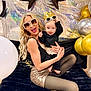 woman, baby, sunglasses, crown, balloons, party, celebration, glamour, joy, smile, black_clothing, gold, silver, sparkle, tights, blanket, indoor, posing, fun, accessories