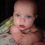 Wyatt is registered to the contest to win money with this photo: baby, blue_eyes, blanket, bald, child, closeup, cute, face, infant, inside, looking, person, portrait, wrapped, young, skin, expression, sleepwear, hand, soft
