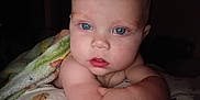 Wyatt is registered to the contest to win money with this photo: baby, bald, blanket, blue_eyes, child, closeup, cute, expression, face, hand, infant, inside, looking, person, portrait, skin, sleepwear, soft, wrapped, young