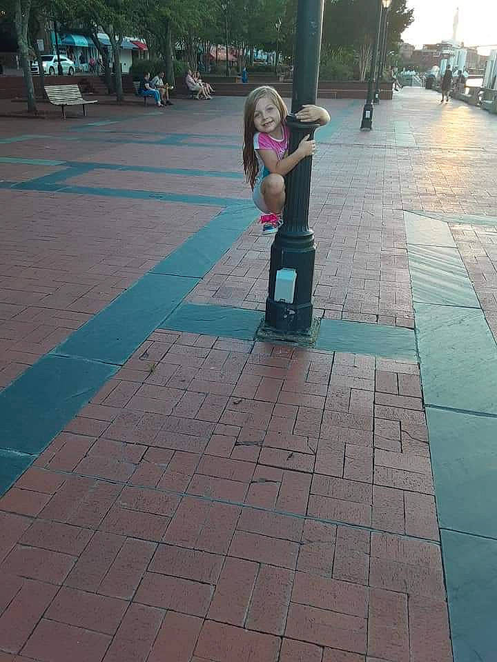 Lily joined the competition — help win amazing prizes! asphalt, child, city, electric_blue, floor, flooring, fun, joy, lane, leg, leisure, pedestrian, person, plant, recreation, road, road_surface, sidewalk, sitting, tints_and_shades