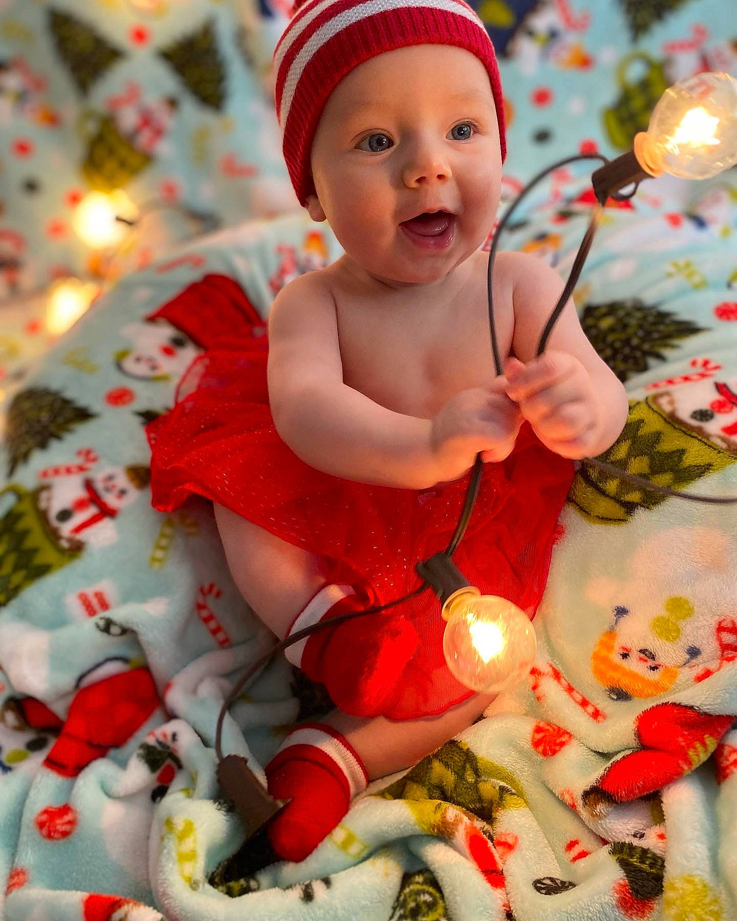 Adalyn is registered to the contest to win money with this photo: baby, baby_toddler_clothing, child, christmas, dress, event, face, happy, head, headwear, holiday, human_body, pattern, person, photograph, red, skin, sleeve, smile, sock