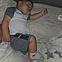 child, toddler, sleeping, nike, socks, shorts, tshirt, couch, blanket, pacifier, indoor, rest, relaxation, person, furniture, home, comfort, cozy, nap, clothing